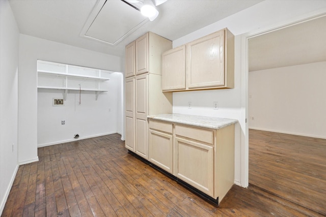 kitchen featuring baseboards, light countertops, and dark wood-style flooring