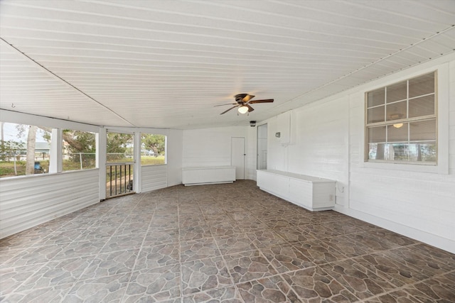 unfurnished sunroom with a ceiling fan