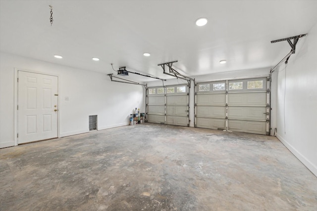 garage with baseboards and a garage door opener