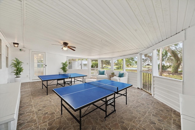 game room featuring a ceiling fan, stone flooring, and wooden ceiling