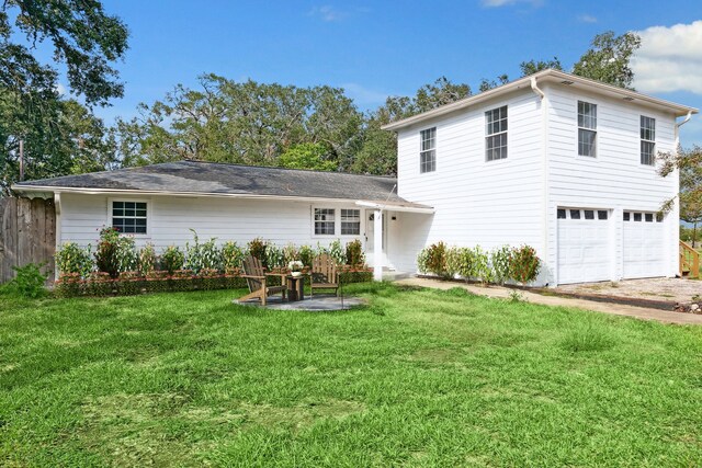 view of front of home featuring a garage and a front lawn