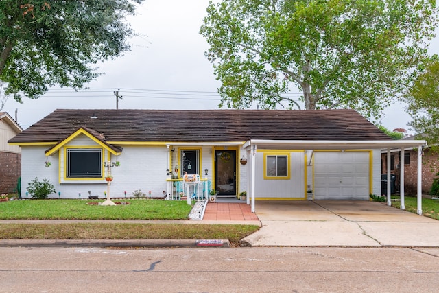 ranch-style house with a carport, a front lawn, and a garage