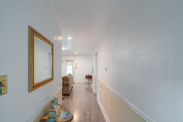 hall featuring ornamental molding and light wood-type flooring