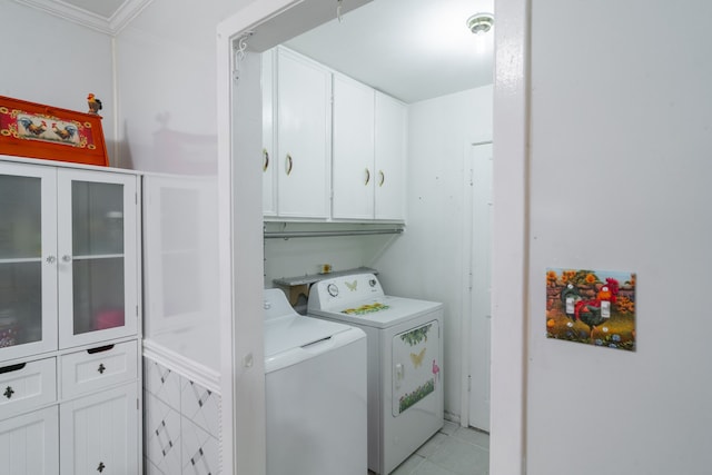 washroom featuring light tile patterned floors, crown molding, separate washer and dryer, and cabinets