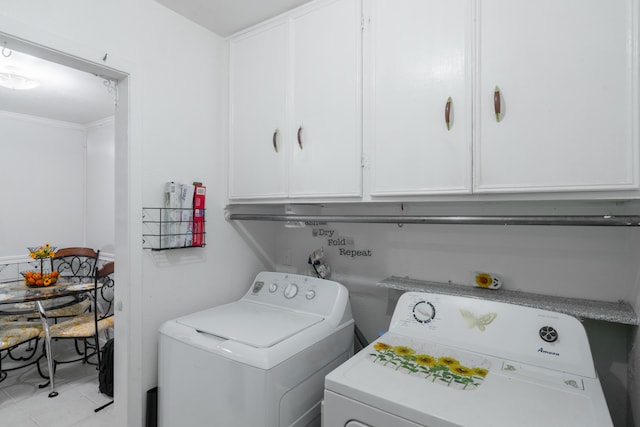 washroom featuring light tile patterned floors, cabinets, and separate washer and dryer