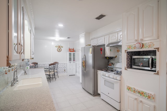 kitchen featuring sink, appliances with stainless steel finishes, and white cabinetry