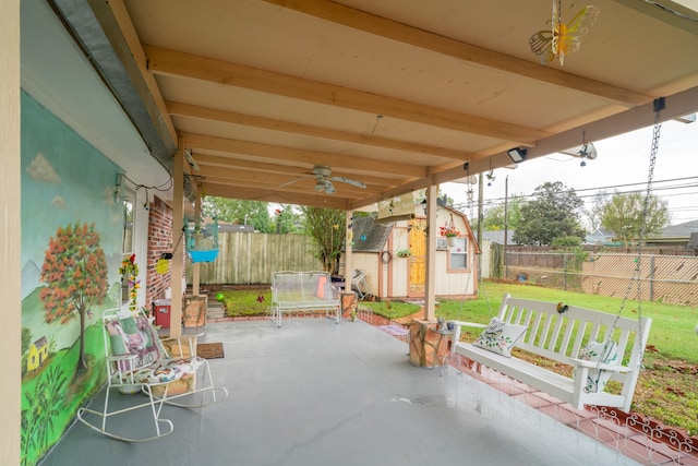 view of patio / terrace with ceiling fan and a shed