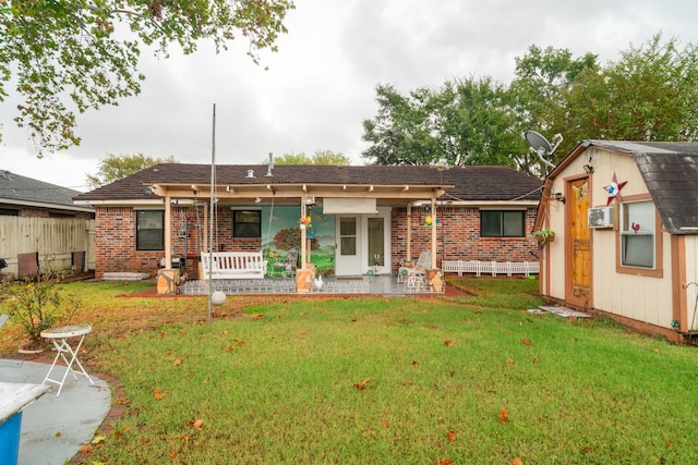 rear view of house with a yard and an outbuilding