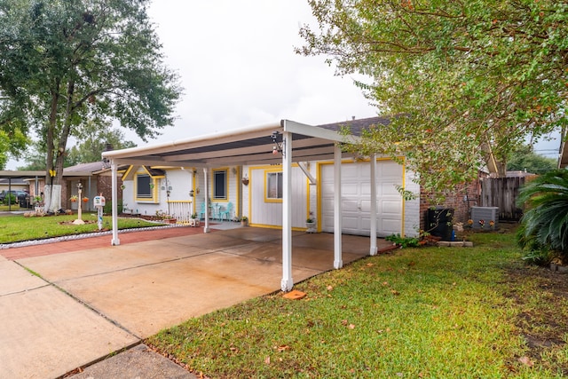 ranch-style house featuring central air condition unit, a front yard, a porch, and a garage