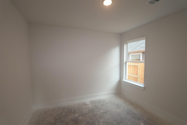 unfurnished room with visible vents and baseboards