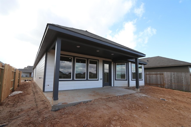 back of property featuring a patio area and a fenced backyard