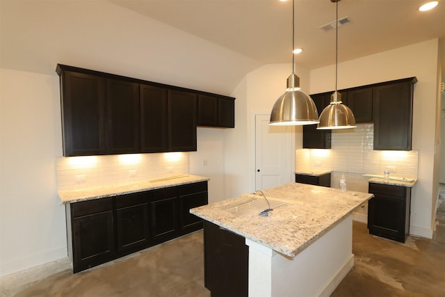 kitchen with light stone counters, visible vents, decorative light fixtures, and vaulted ceiling