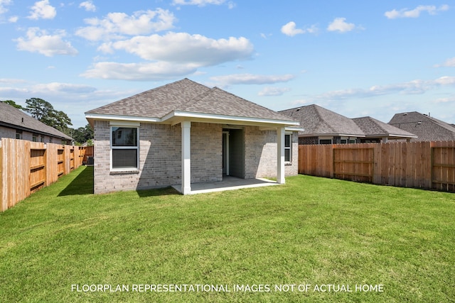 rear view of property featuring a yard and a patio