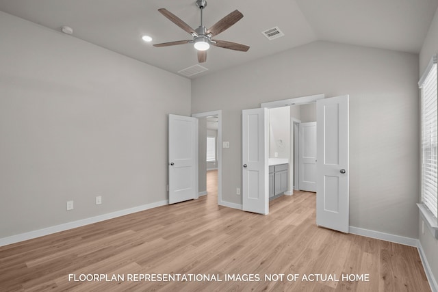 unfurnished bedroom featuring ceiling fan, lofted ceiling, connected bathroom, and light hardwood / wood-style floors