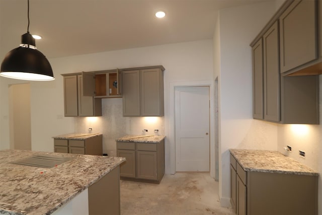 kitchen featuring light stone countertops, hanging light fixtures, and gray cabinets