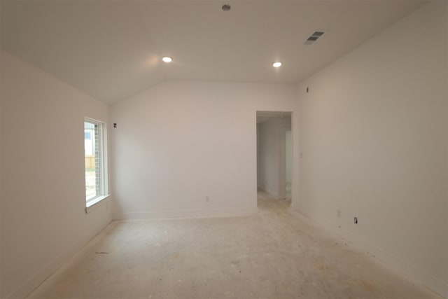 empty room featuring vaulted ceiling