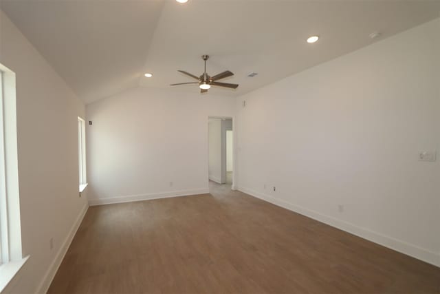 spare room featuring dark hardwood / wood-style flooring, lofted ceiling, and ceiling fan