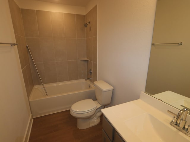 bathroom featuring vanity,  shower combination, toilet, and wood finished floors