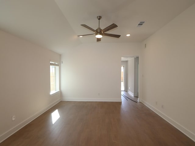 unfurnished room with a ceiling fan, wood finished floors, visible vents, and baseboards