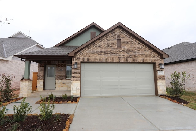 view of front of house featuring brick siding, an attached garage, a shingled roof, and driveway