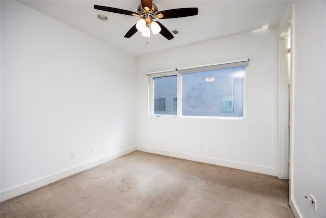 carpeted empty room featuring ceiling fan