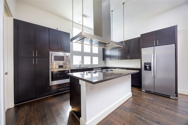 kitchen with a kitchen island, island exhaust hood, stainless steel appliances, and dark hardwood / wood-style floors