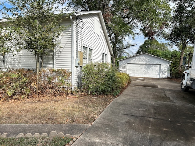 view of property exterior with an outbuilding and a garage