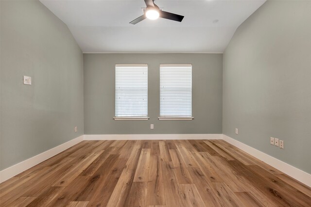 unfurnished room featuring light wood-type flooring and vaulted ceiling