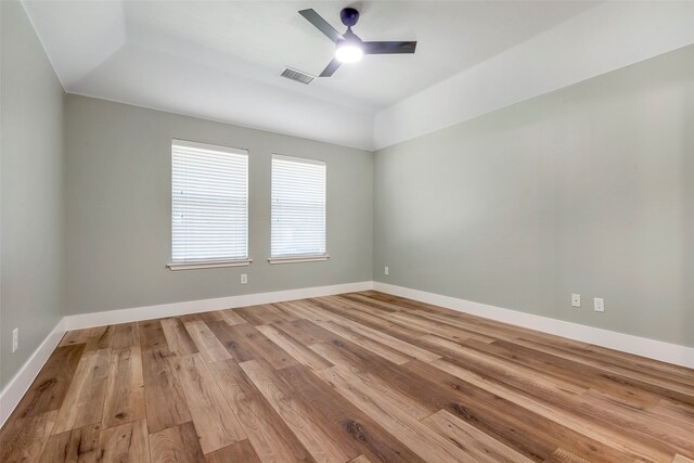 spare room with light wood-type flooring and ceiling fan