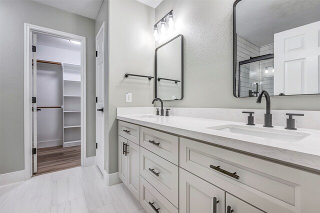 bathroom featuring vanity and a shower with shower door