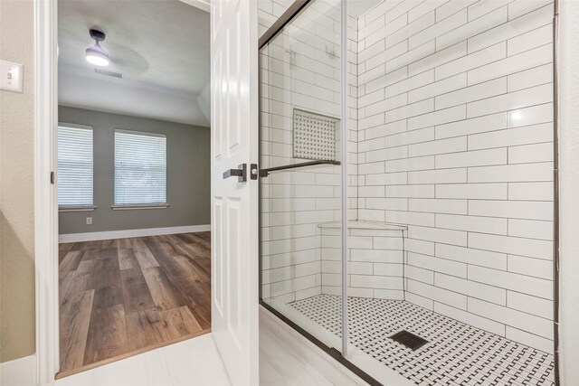 bathroom with wood-type flooring and an enclosed shower