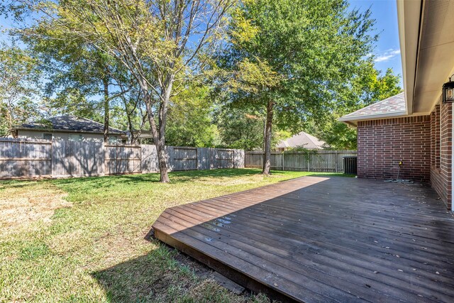 wooden deck with a lawn