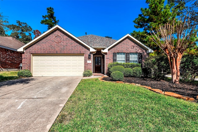 view of front of property featuring a garage and a front lawn