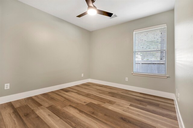 unfurnished room featuring hardwood / wood-style floors and ceiling fan