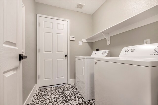 laundry room with washing machine and clothes dryer