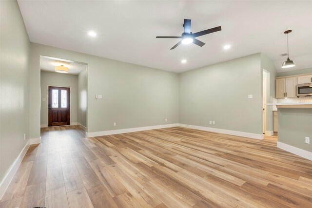 unfurnished living room featuring light hardwood / wood-style floors and ceiling fan