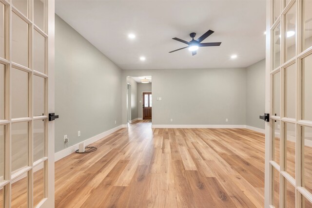 unfurnished room featuring french doors, ceiling fan, and light wood-type flooring