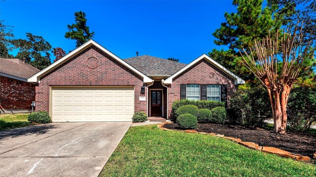 view of front of house featuring a front lawn and a garage