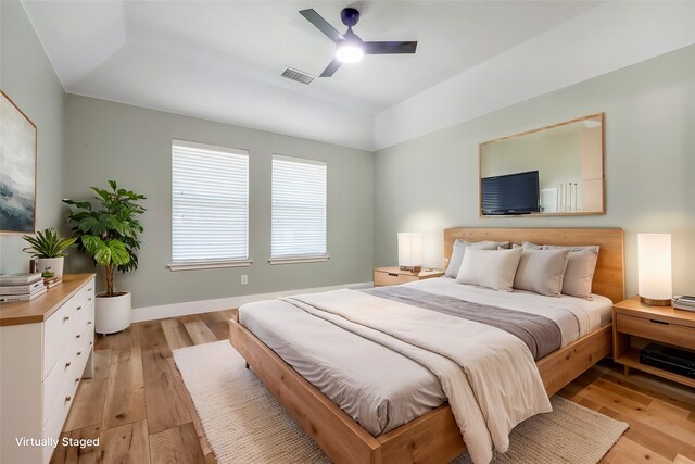 bedroom with light hardwood / wood-style floors and ceiling fan