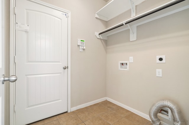 clothes washing area featuring hookup for a washing machine, light tile patterned floors, and electric dryer hookup