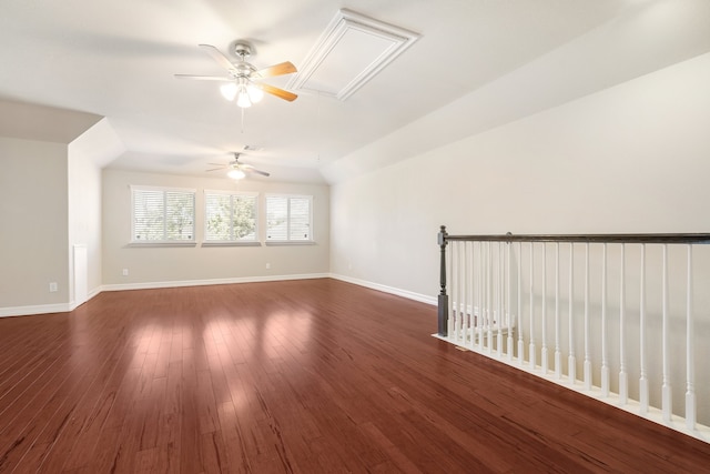 unfurnished room with vaulted ceiling and dark hardwood / wood-style flooring