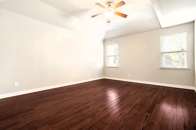 unfurnished room with dark wood-style floors, baseboards, and a ceiling fan