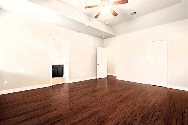 interior space featuring dark wood-style flooring, visible vents, ensuite bath, and baseboards