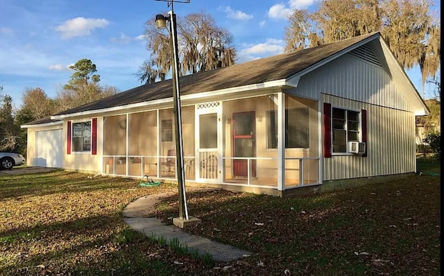 view of side of home with a sunroom