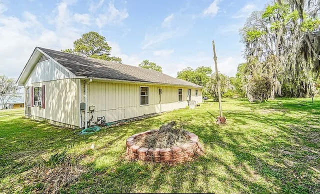 view of side of home with a yard