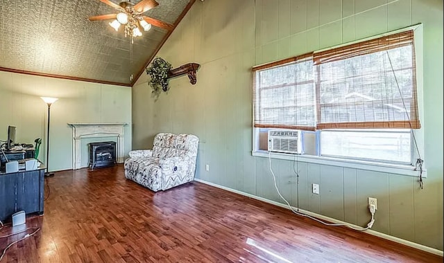 unfurnished room with wood-type flooring, a wood stove, ceiling fan, high vaulted ceiling, and ornamental molding