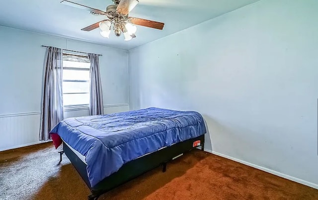 bedroom with dark carpet and ceiling fan