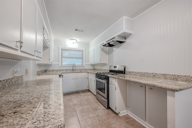 kitchen featuring sink, white cabinetry, wall chimney exhaust hood, ornamental molding, and stainless steel gas range