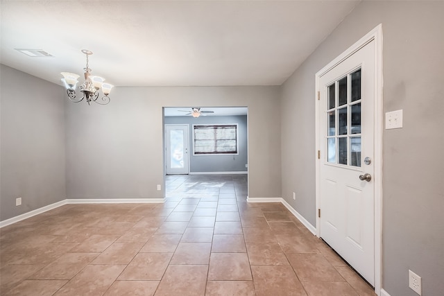 interior space with ceiling fan with notable chandelier and light tile patterned floors