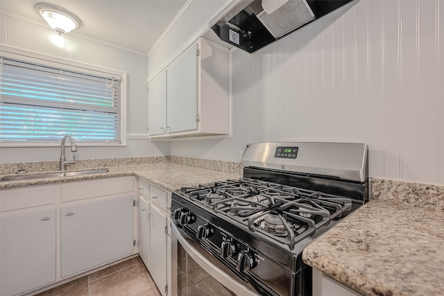 kitchen with stainless steel gas range, sink, white cabinetry, and crown molding